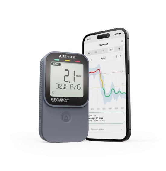 Airthings Corentium Home 2 radon detector next to a phone showing the app