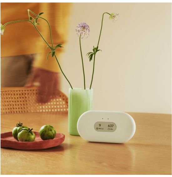 Airthings View Plus air quality monitor on a wooden table
